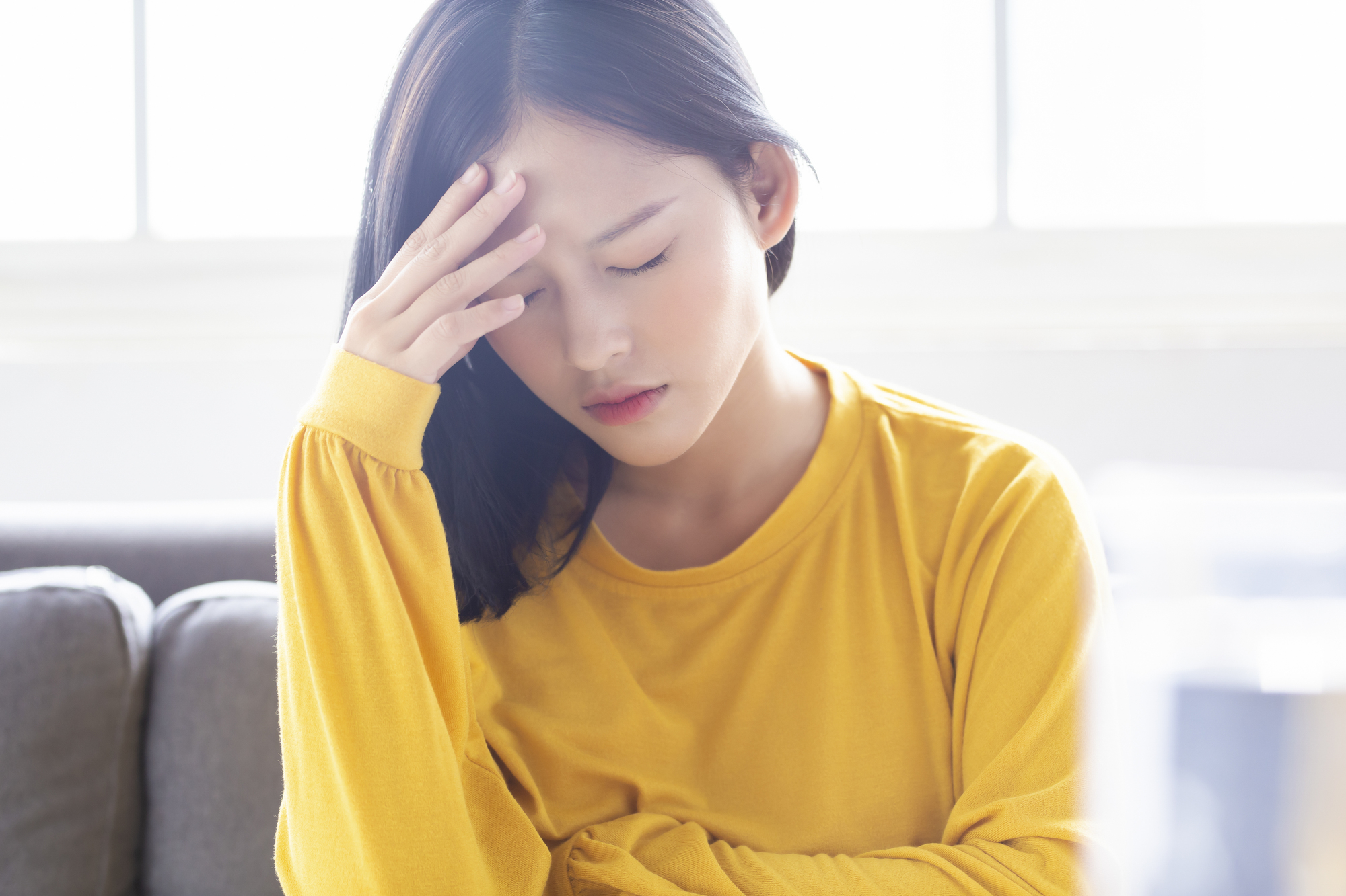 頭をおさえる女性